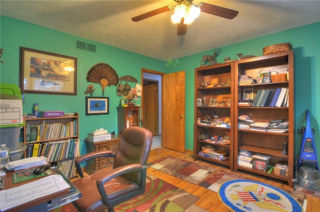 office with wood finished floors, visible vents, and a ceiling fan