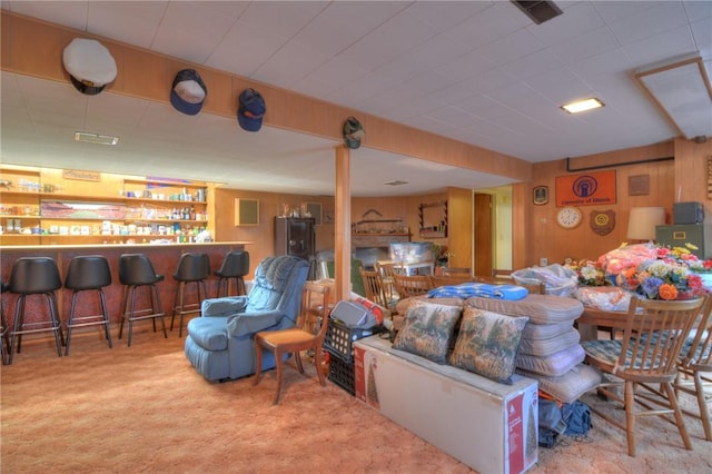 living room with a dry bar, carpet, and visible vents