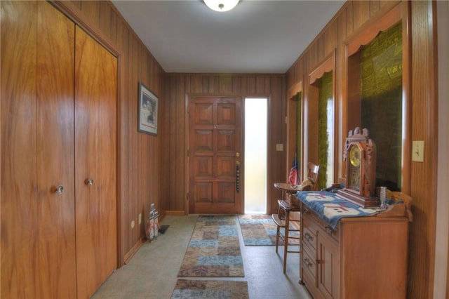 foyer featuring wooden walls and a wealth of natural light