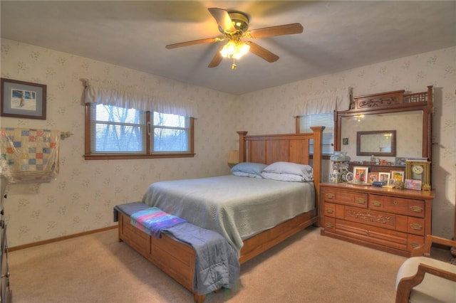 bedroom with light carpet, ceiling fan, baseboards, and wallpapered walls