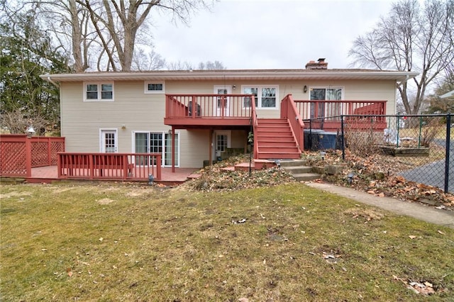 back of house featuring a yard, a chimney, stairway, fence, and a wooden deck