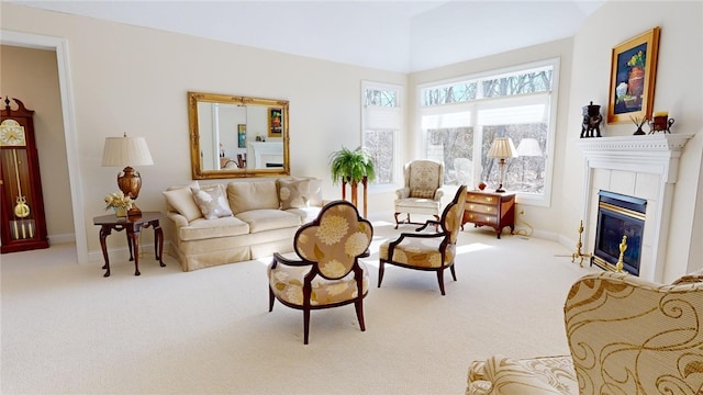 living room with a tiled fireplace and light colored carpet