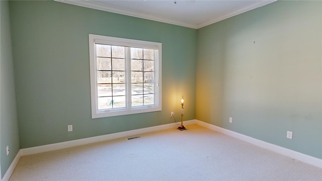 carpeted empty room featuring crown molding