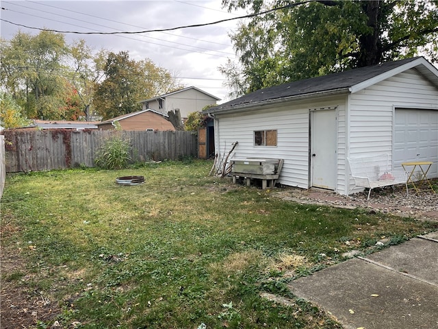 view of yard featuring an outbuilding and an outdoor fire pit