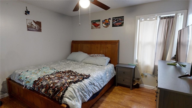 bedroom with light hardwood / wood-style flooring and ceiling fan