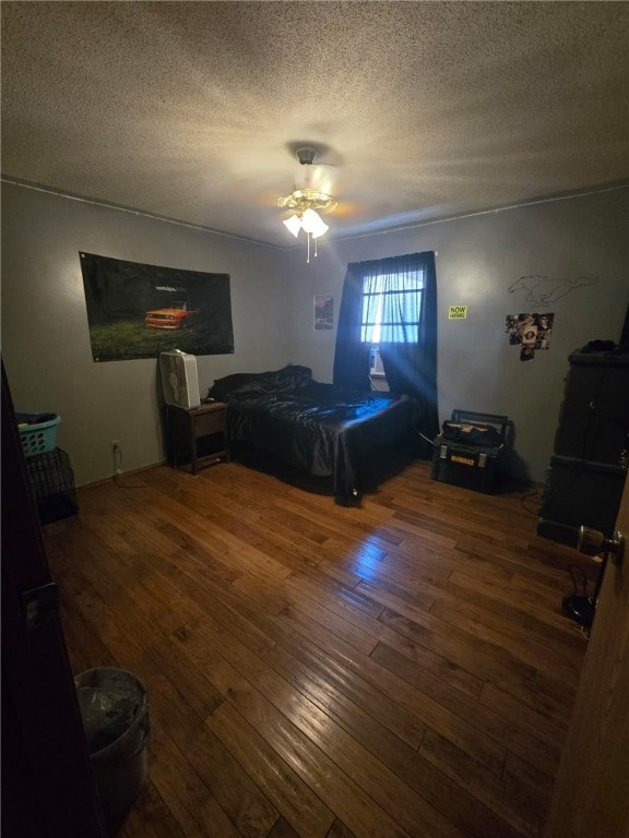 208 Roosevelt St, Paris, IL 61944 - bedroom featuring hardwood / wood-style floors, a textured ceiling, and a ceiling fan