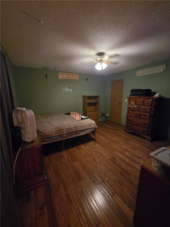208 Roosevelt St, Paris, IL 61944 - bedroom featuring hardwood / wood-style flooring, a textured ceiling, and a ceiling fan