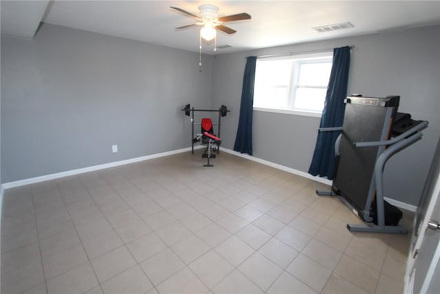 exercise room featuring a ceiling fan, visible vents, baseboards, and light tile patterned flooring