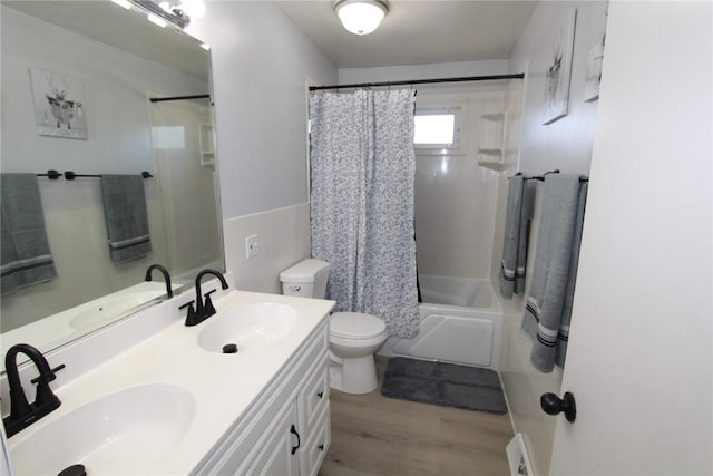 full bath with shower / tub combo, a sink, and toilet