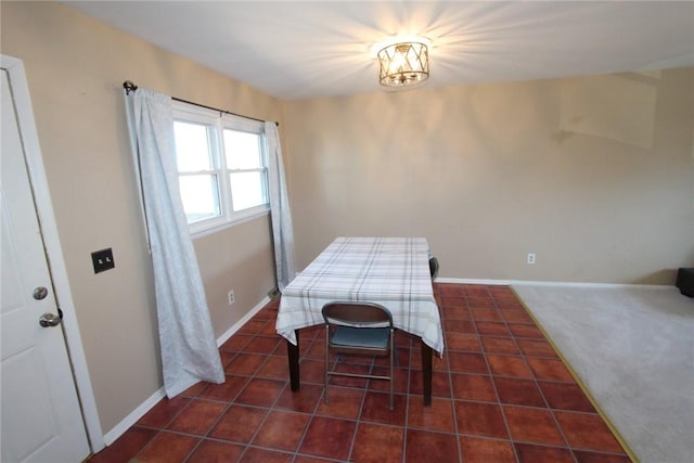 dining space featuring tile patterned floors and baseboards