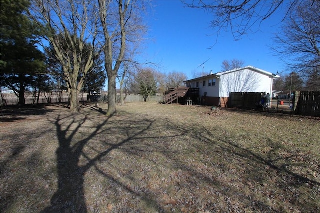 view of side of property with stairway and fence