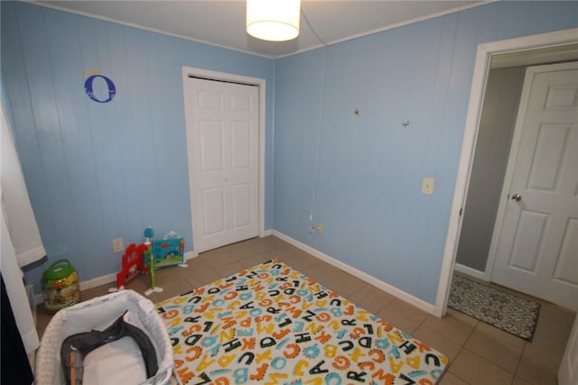 game room with baseboards and tile patterned floors