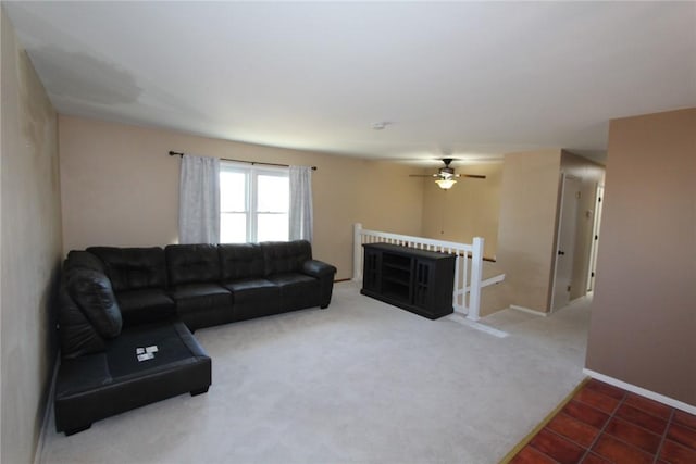 living room featuring carpet flooring, baseboards, and tile patterned floors