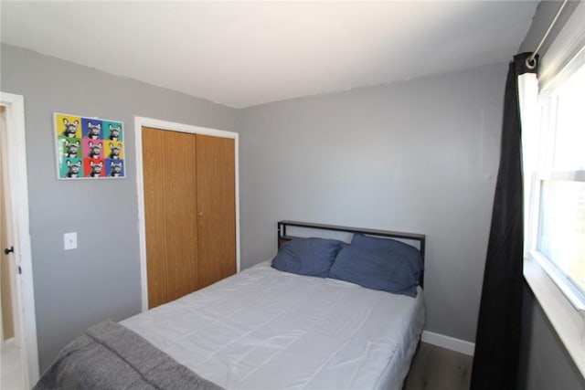 bedroom featuring a closet and baseboards