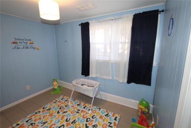 rec room featuring tile patterned flooring, visible vents, and baseboards