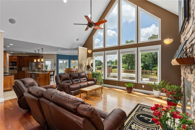 11107 E Cambridge Ln, Effingham, IL 62401 - living room featuring high vaulted ceiling, a stone fireplace, wood finished floors, a ceiling fan, and recessed lighting