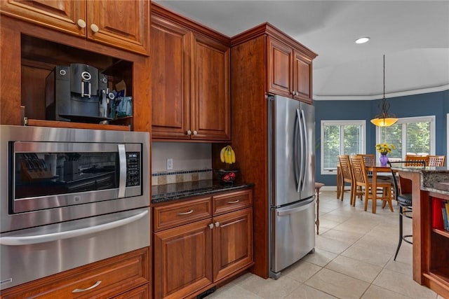 11107 E Cambridge Ln, Effingham, IL 62401 - kitchen featuring appliances with stainless steel finishes, a warming drawer, ornamental molding, light tile patterned floors, and dark stone countertops