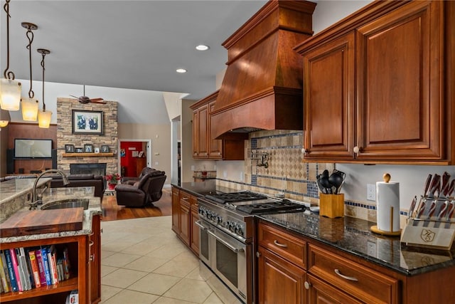 11107 E Cambridge Ln, Effingham, IL 62401 - kitchen featuring range with two ovens, a ceiling fan, custom range hood, open floor plan, and a fireplace