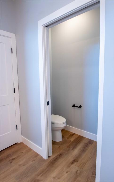 3812 Sonny Ln, Danville, IL 61832 - bathroom with toilet, wood finished floors, and baseboards