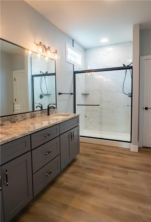 3812 Sonny Ln, Danville, IL 61832 - full bathroom featuring vanity, a marble finish shower, and wood finished floors