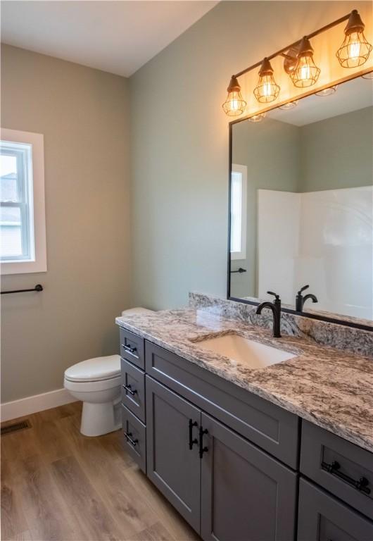 3812 Sonny Ln, Danville, IL 61832 - bathroom with vanity, wood finished floors, and toilet