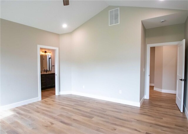 3812 Sonny Ln, Danville, IL 61832 - empty room featuring light wood-type flooring, a ceiling fan, baseboards, and high vaulted ceiling