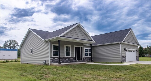 3812 Sonny Ln, Danville, IL 61832 - craftsman-style house featuring a garage, driveway, a front lawn, and covered porch