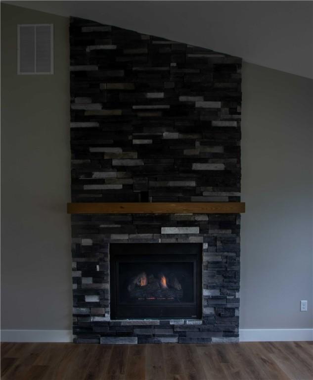 3812 Sonny Ln, Danville, IL 61832 - detailed view of a fireplace, wood finished floors, and baseboards