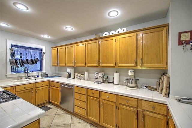 3985 E Cerro Gordo St, Decatur, IL 62521 - kitchen with a sink, stainless steel dishwasher, tile countertops, brown cabinets, and light tile patterned floors