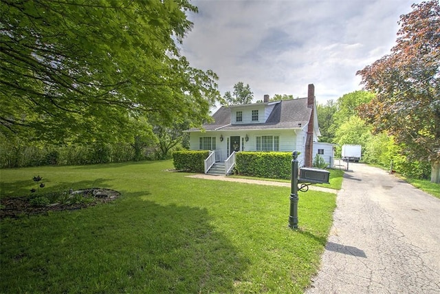 3985 E Cerro Gordo St, Decatur, IL 62521 - bungalow-style home with a chimney, a front yard, and asphalt driveway