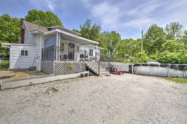 3985 E Cerro Gordo St, Decatur, IL 62521 - view of front of home with a porch, a covered pool, and view of scattered trees