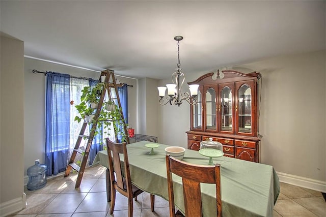 3985 E Cerro Gordo St, Decatur, IL 62521 - dining room with a chandelier, light tile patterned floors, and baseboards
