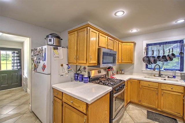 3985 E Cerro Gordo St, Decatur, IL 62521 - kitchen featuring stainless steel appliances, a sink, tile counters, light tile patterned floors, and recessed lighting