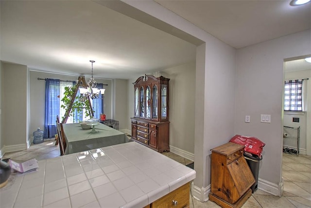 3985 E Cerro Gordo St, Decatur, IL 62521 - dining space with light tile patterned floors, baseboards, and a chandelier