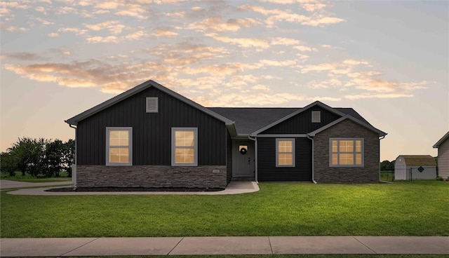 1121 Meadow Brook Ct, Mattoon, IL 61938 - view of front of house featuring stone siding, a front yard, and board and batten siding