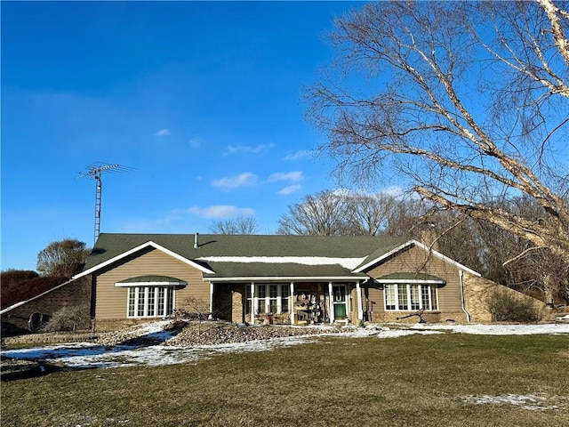 ranch-style home with a yard