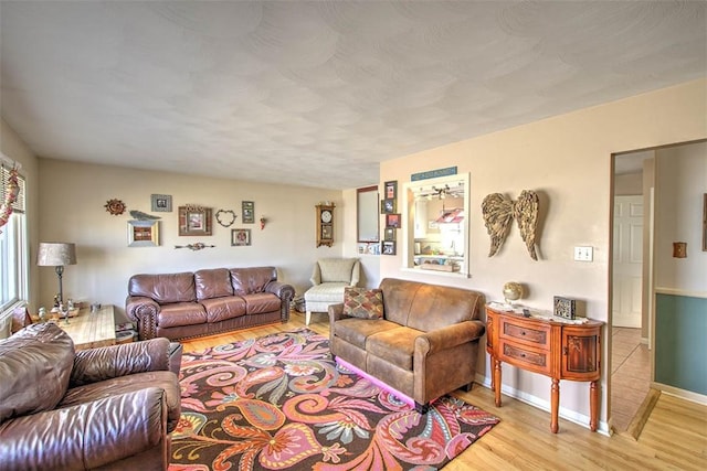 living area with light wood-style flooring and baseboards