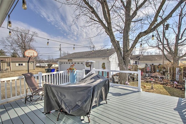 wooden deck featuring an outbuilding and fence