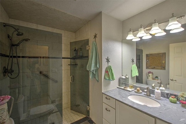 full bathroom featuring vanity, a shower stall, and toilet