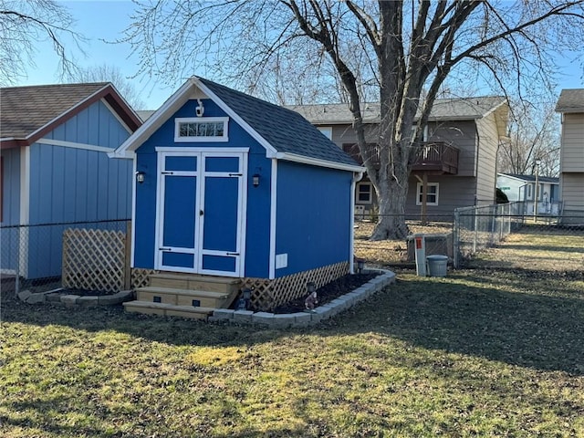 view of shed with entry steps and fence