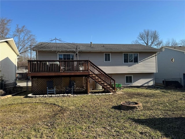 rear view of property with stairway, fence, an outdoor fire pit, a deck, and a lawn