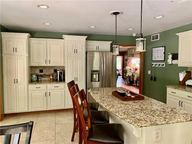 15690 E 1100th Ave, Effingham, IL 62401 - kitchen featuring stainless steel fridge, decorative backsplash, a kitchen island, light stone countertops, and recessed lighting