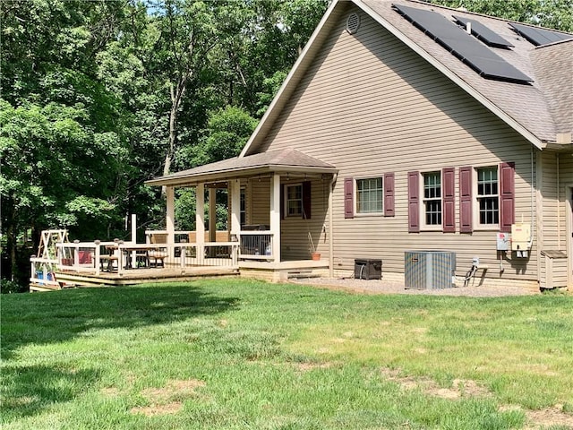 15690 E 1100th Ave, Effingham, IL 62401 - rear view of house with a lawn, solar panels, and a shingled roof