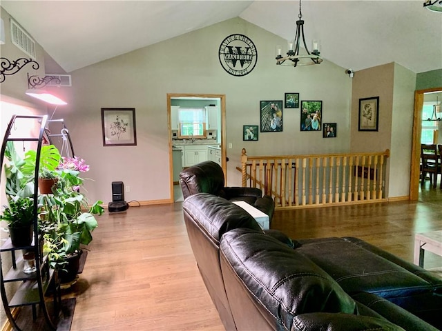 15690 E 1100th Ave, Effingham, IL 62401 - living area with a chandelier, wood finished floors, and high vaulted ceiling