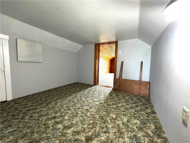 bonus room with carpet floors and vaulted ceiling
