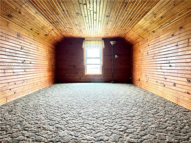 additional living space with wood walls, carpet flooring, wooden ceiling, and lofted ceiling