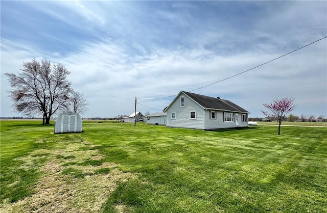view of side of home with an outbuilding, a lawn, and a storage unit