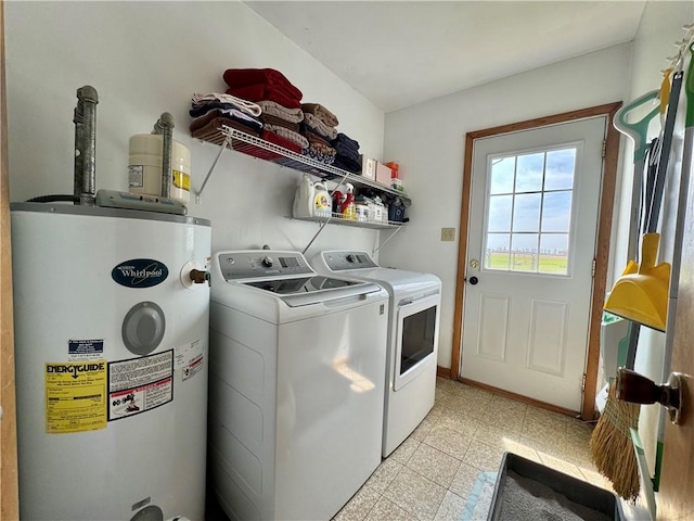 clothes washing area featuring washer and dryer, laundry area, and electric water heater