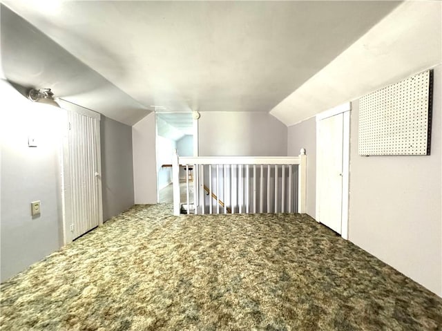 bonus room with carpet and vaulted ceiling