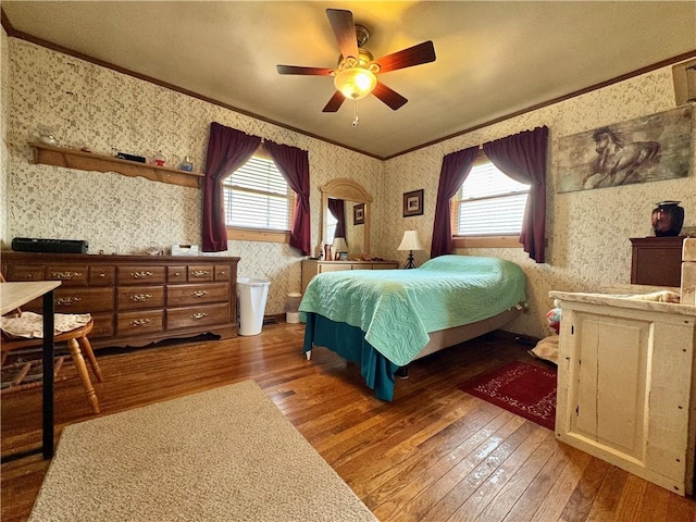 bedroom with crown molding, wallpapered walls, hardwood / wood-style floors, and multiple windows